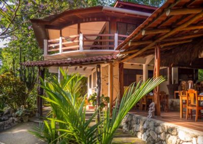 Outside view of Encanta La Vida eco-lodge in Matapalo Costa Rica, surrounded by tropical gardens and beachfront jungle