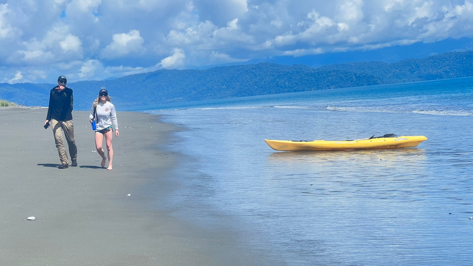 Couple kayaking at sunrise in front of Osa Peninsula beachfront hotel in Matapalo Costa Rica